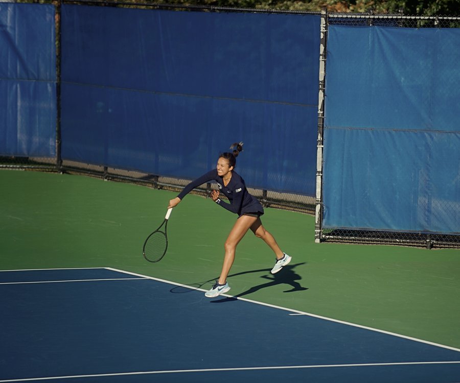 Serving during a competitive match at Penn State